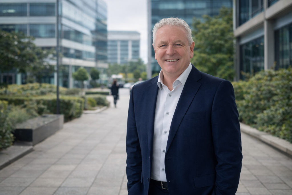 Keith Farrell, marketing consultant in Scotland, standing in a modern urban business district.