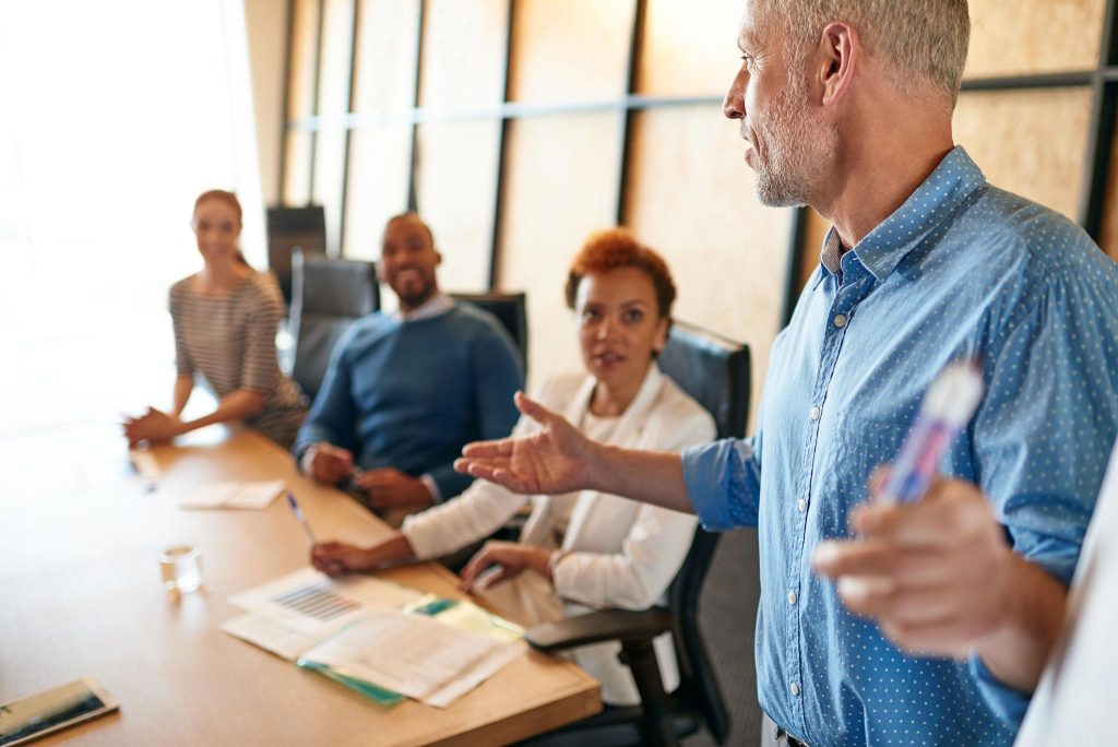 Interim marketing leader guiding SME directors in a strategic meeting in a Scottish office